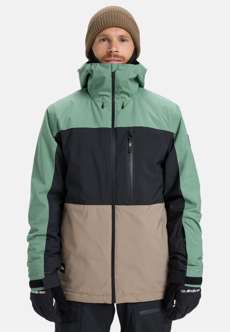 Men's color-blocked jacket featuring a mint green, black, and tan design. Made of waterproof material with a high collar and zippered chest pocket.