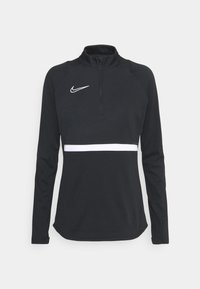 Musta, pitkähihainen urheilupaita, jossa on puolikaulus, vetoketju, valkoinen vaakasuora raita ja Nike-logo vasemmassa rinnassa. Pehmeää, joustavaa kangasta.