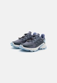 Navy trail running shoes with textured fabric upper, white midsole, and blue rubber outsole. Features a quick-lacing system and padded collar.