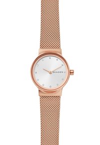 Náramkové hodinky s růžově zlatým kovovým páskem a stříbrným ciferníkem, se zaměřením na malé krystaly jako hodinové značky a minimalistickým designem. Logo značky je viditelné.