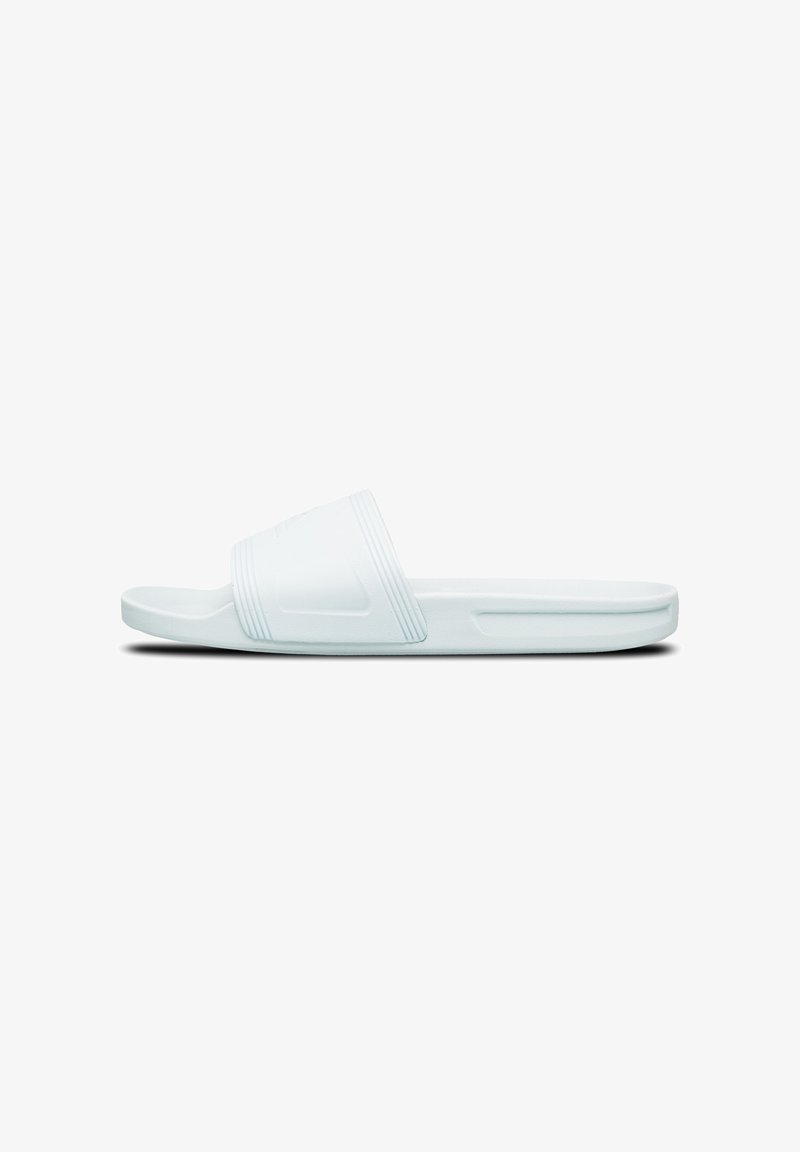 White slide sandal made of smooth rubber with a wide strap featuring horizontal grooves and a flat, subtle textured footbed.