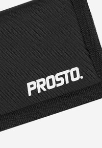Czarny portfel wykonany z materiału o fakturowej powierzchni, z białym logo "PROSTO.". Widoczne przeszycia na krawędziach wskazują na solidną konstrukcję.