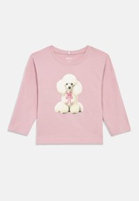 Pink long-sleeve toddler shirt with a white poodle and pink ribbon printed on the front, round neckline, and soft fabric.