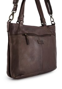 Braune Lederhandtasche mit einer Reißverschlusstasche vorne, verstellbaren Trägern und einer glatten, leicht glanzenden Oberfläche. Sichtbares Logo-Detail.
