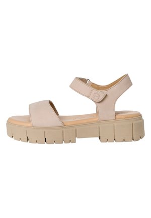 Beige leather sandal with two straps: one across the forefoot and one around the ankle. Thick, textured sole with grooves for grip.