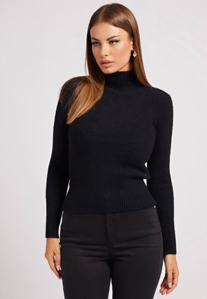 Maglione nero a collo alto a coste con maniche lunghe, realizzato in materiale a maglia testurizzato, design aderente e orlo sottile.