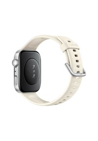 Smartwatch with a black face, silver side accents, and a cream silicone strap featuring circular holes for adjustability.