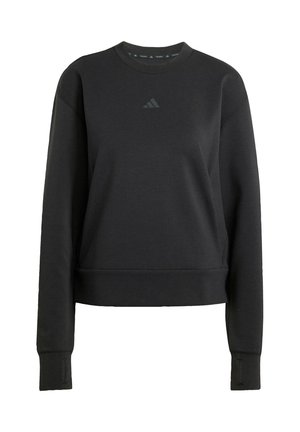 Musthave must tume, mis on pehmest kangast, ümmarguse kaelusega, pikkade varrukatega ja keskel on diskreetne logo. Sile tekstuur.