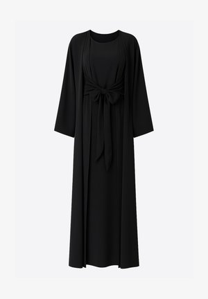 Czarna sukienka o zwiewnym fasonie, z długimi rękawami i wiązaniem z przodu. Wykonana z gładkiej tkaniny, z skromnym dekoltem i sylwetką.