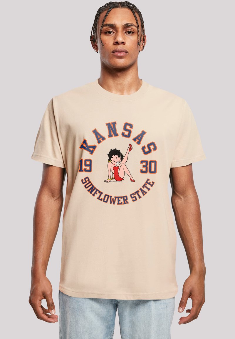 Beige cotton t-shirt featuring a graphic of a woman in red with the text "KANSAS 1930 SUNFLOWER STATE" in blue accents around it.