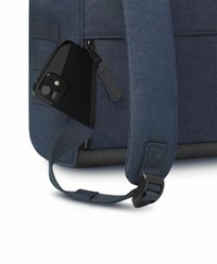Navy backpack featuring a zipper, holding a black smartphone. The bag has a textured finish and an adjustable strap with a plastic buckle.