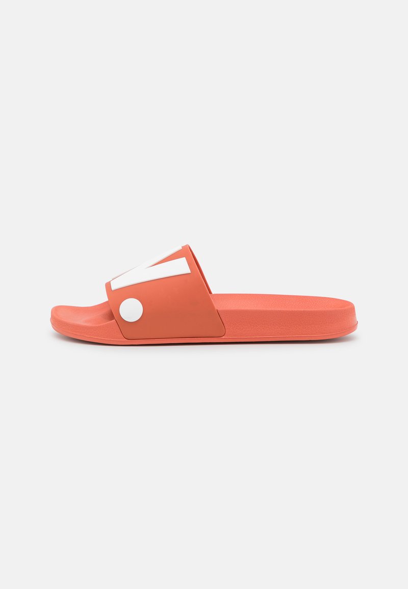 Coral slide sandal with a wide upper strap featuring a white accent. Smooth plastic material and flat sole. Lightweight design for easy wear.