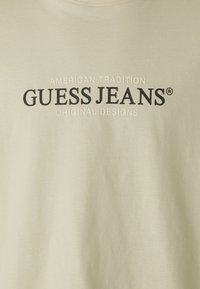 Guess Jeans Triko s potiskem - beige