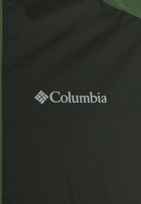 Tissu vert foncé avec un motif texturé, arborant le logo "Columbia" en blanc. Le design est simple et fonctionnel.