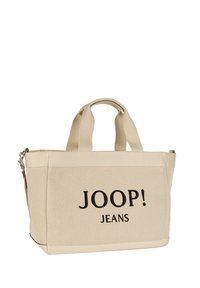 Beżowa płócienna torba na ramię z dwoma krótkimi uchwytami, z haftowanym czarnym logo "JOOP! JEANS" na przodzie oraz zamkiem błyskawicznym.