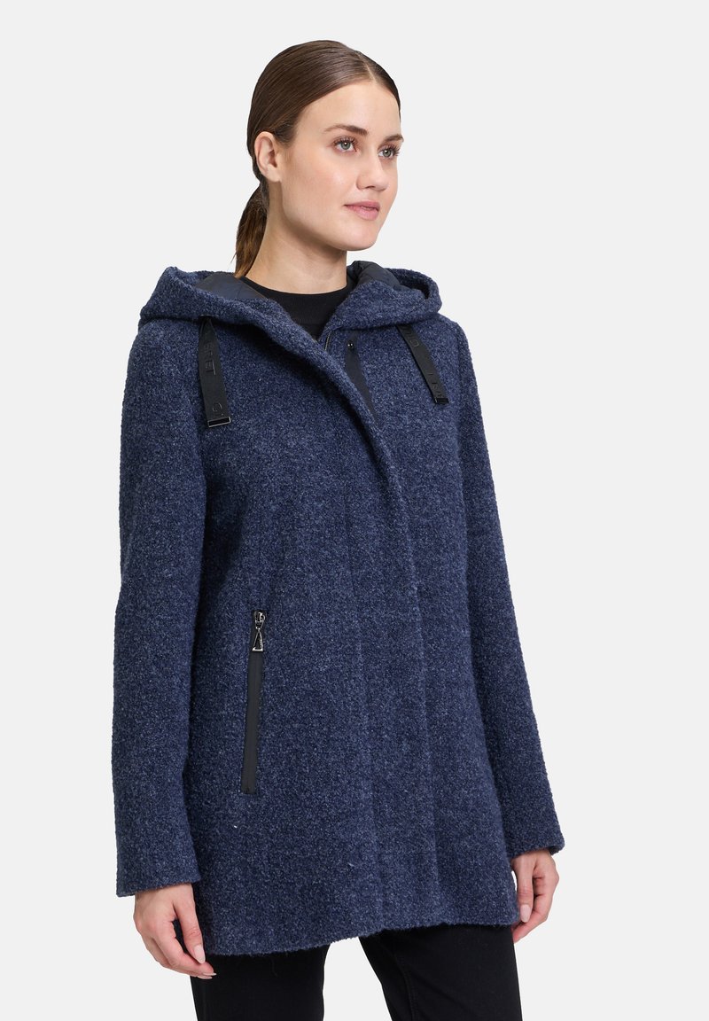 Granatowy płaszcz z mieszanki wełny z kapturem, z czarnymi kieszeniami na zamek, teksturowanym wykończeniem i luźnym krojem.