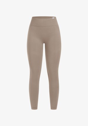 Leggings taille haute beige en tissu stretch, offrant une texture lisse et une silhouette ajustée, sans coutures ni motifs visibles.