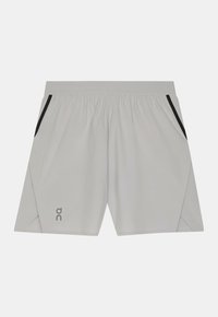 Helehallid sportpüksid, millel on elastne vöökoht, mustad küljetaskud ja logo alumisel vasakul küljel. Kangas tundub sile ja kerge.