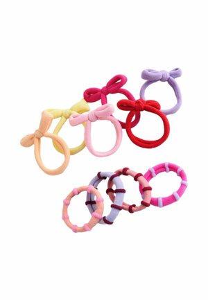 Assorted fabric hair ties in various colors including yellow, pink, red, and purple, featuring bows and textured details.