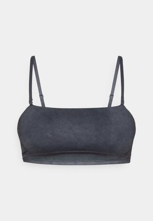 Bralette gris foncé avec des bretelles fines et ajustables, texture de tissu lisse, et un design simple et épuré sans rembourrage ni fermetures.