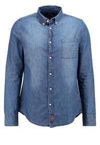 Camisa de mezclilla azul claro con cuello abotonado, mangas largas y un único bolsillo en el pecho; presenta una sutil textura desgastada.