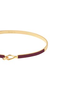 Bracelet en or avec une section en émail bordeaux et un design de fermoir délicat, texture lisse avec une finition polie.