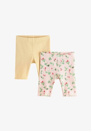 To par ribbede leggings til småbørn, den ene i ensfarvet bleg gul og den anden lyserød med et grønt blad- og rødt bærblomstermønster.