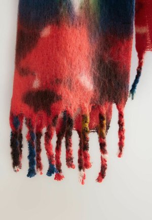 Soft mohair scarf with multicolor gradient in red, blue, green, and brown hues, featuring twisted fringe tassels on a light background.