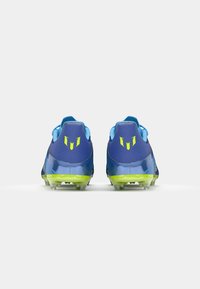 Blue soccer cleats with a shiny finish, featuring yellow accents and a textured design. Clear studs provide traction on grass surfaces.