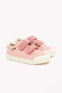Pink canvas sneakers feature elastic Velcro straps, a white rubber sole, and subtle texture. Accented with a logo patch on the side.