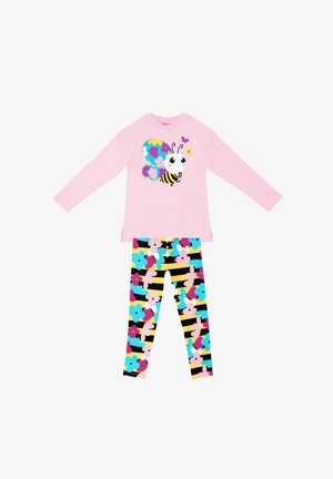 Lys rosa langærmet skjorte med et multicolor sommerfuglgrafik; parret med sorte leggings mønstret med farverige blomster og striber.