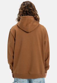 Brown hoodie with a drawstring hood, relaxed fit, and ribbed cuffs and hem. Soft texture, minimalistic design, no visible logos or patterns.