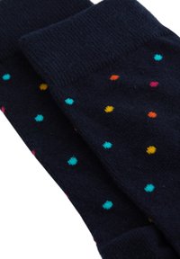 Marina blå strumpor gjorda av mjukt stickat material, med flerfärgade prickar i rosa, orange, gult och ljusblått.