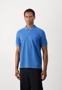 Blue polo shirt with a two-button placket, short sleeves, and a subtle logo on the chest. Fabric appears smooth and lightweight.