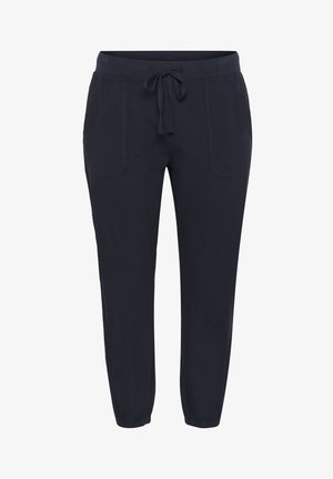 Laivastonsiniset naruhousut, joissa on vinot taskut, kapeneva lahkeiden malli, elastiset hihnat ja sileä puuvillakangas.