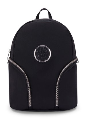 Black nylon backpack with a rounded top, silver zippers, and a circular logo patch on the front. Features two zipper pockets at the sides.