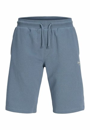 Sinised vabaajapüksid, millel on elastne vöökoht ja ees nöörid, küljetaskud ning väikene brändi logo paremal reiel.