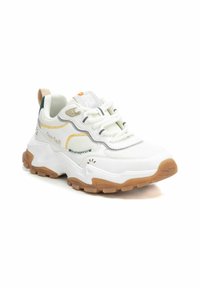 Zapatillas deportivas blancas con una superficie texturizada, acentos en amarillo y verde, suelas de goma gruesas y una pestaña de talón reforzada. Incluye detalles en los cordones y en el logo.
