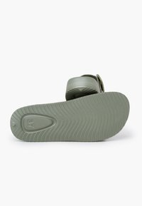 Green rubber sandal with a textured, grooved sole. Strap design features a smooth finish. Size marked as 37 on the underside.