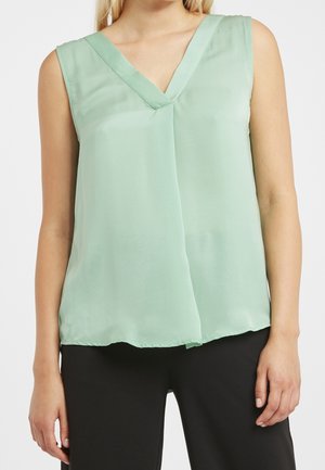 Blusa senza maniche verde chiaro con scollatura a V e design fluido. Realizzata in un tessuto liscio con una leggera lucentezza.