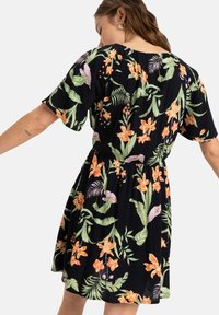Black floral dress featuring short sleeves, a fitted waist, and vibrant orange and green flower patterns against a dark background.