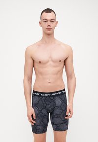 Fekete kígyómintás alsónadrág vastag fekete derékkal, fehér "Jordan Sport" felirattal. Rugalmas anyagból készült.