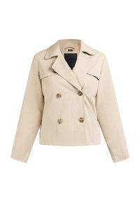 Veste beige à double boutonnage en tissu lisse, avec col à revers, grands boutons ronds et poches avant, coupe courte.