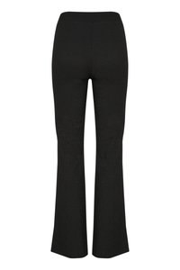 Sorte flagrende bukser laget av et teksturert stoff, med elastisk midje og en glatt finish, designet for en tettsittende look under midjen.