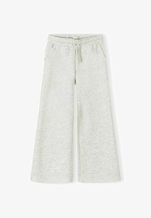 Pantalon de survêtement gris clair à jambes larges avec une taille élastique, un cordon de serrage et des poches latérales, posé à plat sur un fond blanc.