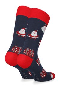 Granatowe skarpetki z czerwonymi ściągaczami, zdobione wzorami z Mikołajem i prezentami. Wykonane z miękkiego materiału, z wzmocnionymi palcami i piętami.