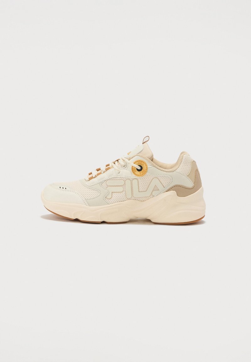 Beige athletic shoe with mesh and suede materials. Features prominent logo, round eyelets, and a cushioned sole. Unembellished design.