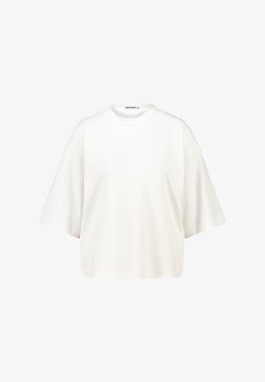 Valkoinen ylisuurikokoinen lyhythihainen T-paita, jossa on pyöreä kaula-aukko ja laskeutuvat olkapäät, tasaisella valkoisella taustalla.