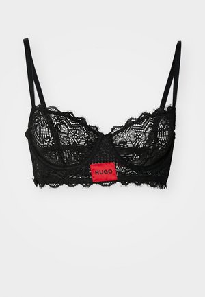 Black lace bralette with scalloped edges, underwire support, and adjustable straps. Features a central red tag with "HUGO" logo.