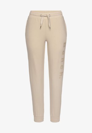 Beige jogger pants in soft fabric, featuring a drawstring waist, side pockets, and printed "Bench." logo in a subtle tone on one leg.